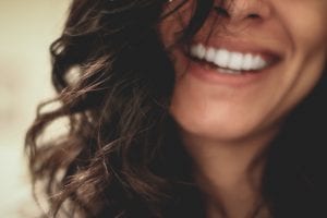 Woman smiling; image by Leslie Juarez, via Unsplash.com.