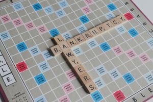 Scrabble board with tiles spelling out “Bankruptcy Attorney;” image by Melinda Gimpel, via Unsplash.com.