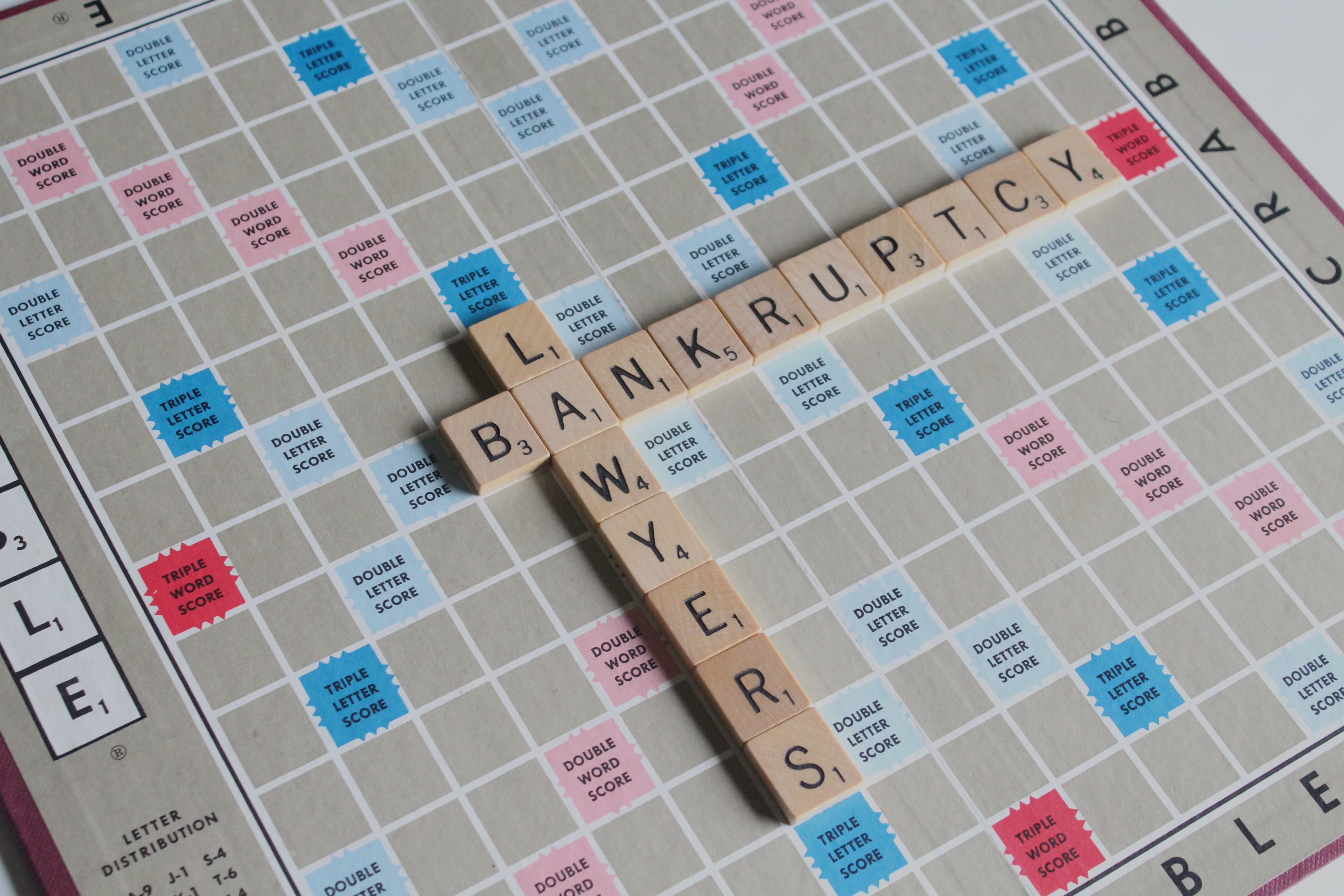 Scrabble board with tiles spelling out “Bankruptcy Lawyers;” image by Melinda Gimpel, via Unsplash.com.