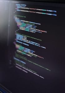 Lines of computer code on a monitor; image by Oscar Nord, via Unsplash.com.