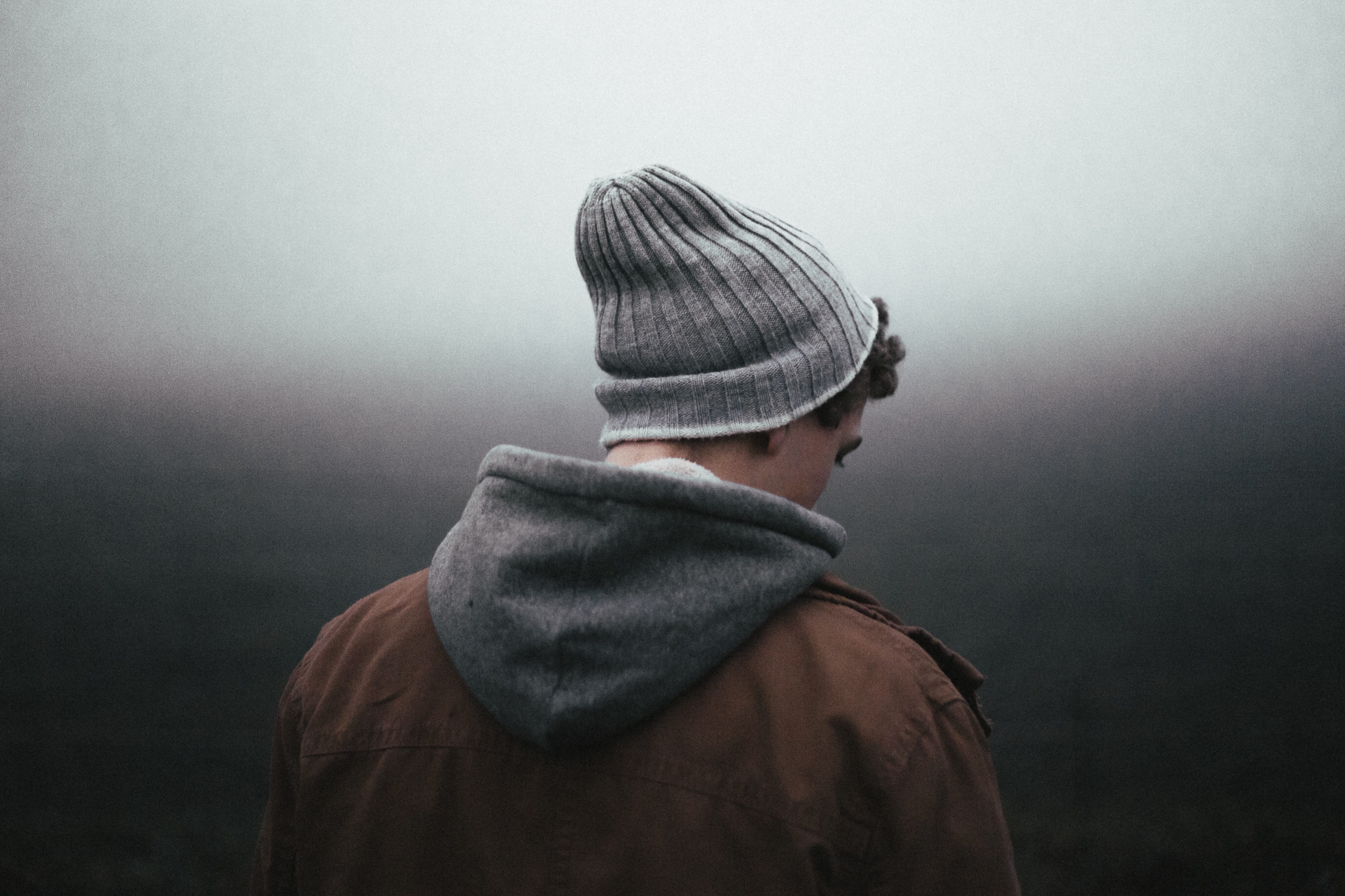 Young man wearing knit cap, turned with back to camera; image by Andrew Neel, via Unsplash.com.
