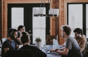 A group of people working together at a common area; image by Annie Sprat, via Unsplash.com.