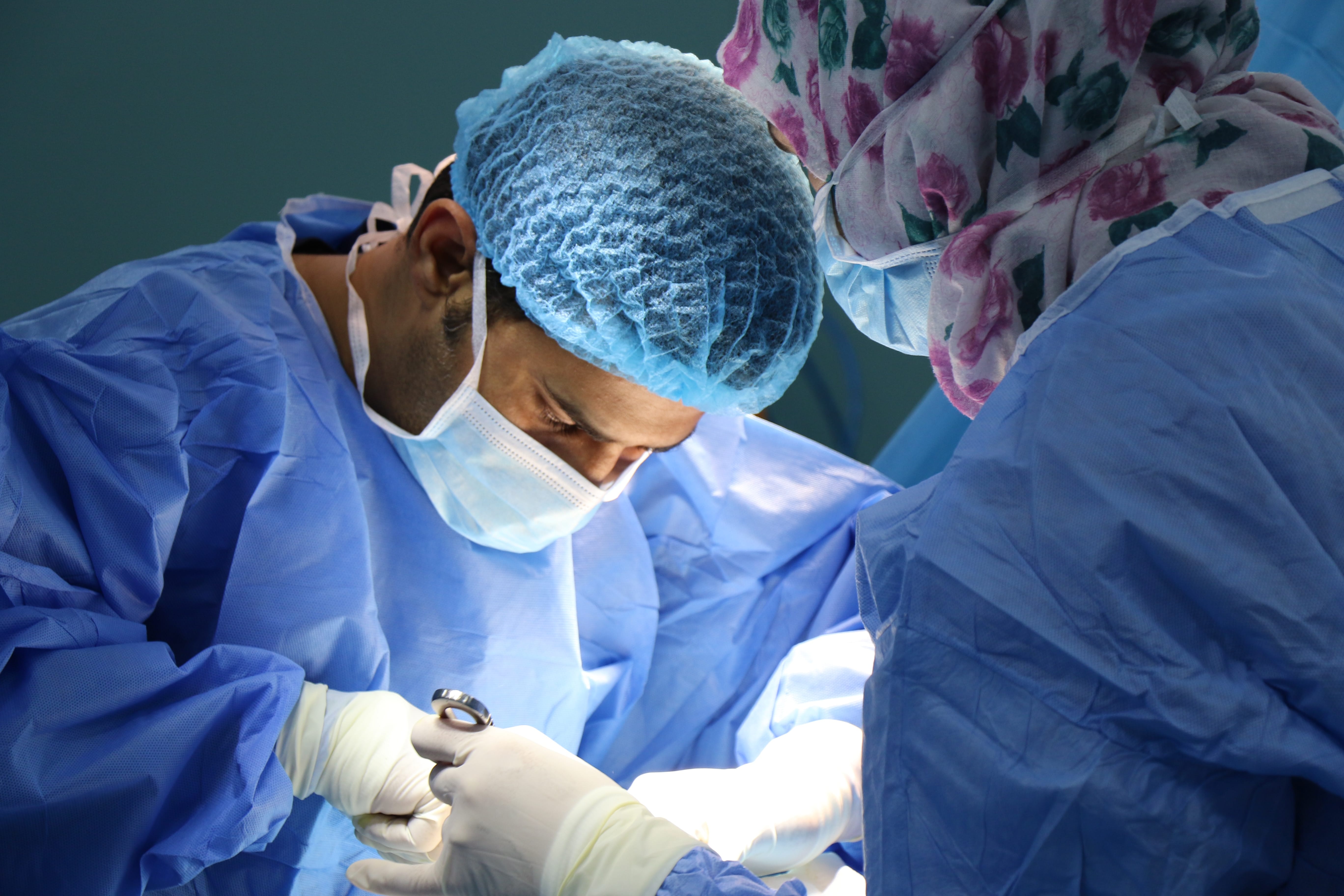 Doctor performing surgery; image by Jafar Ahmed, via Unsplash.com.