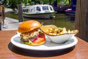 Burger and salad on a tray; image by Louis Hansel, via Unsplash.com.