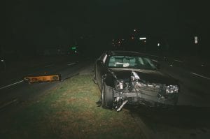 Car accident at night showing vehicle with front-end damage; image by Matthew T. Rader, via Unsplash.com.