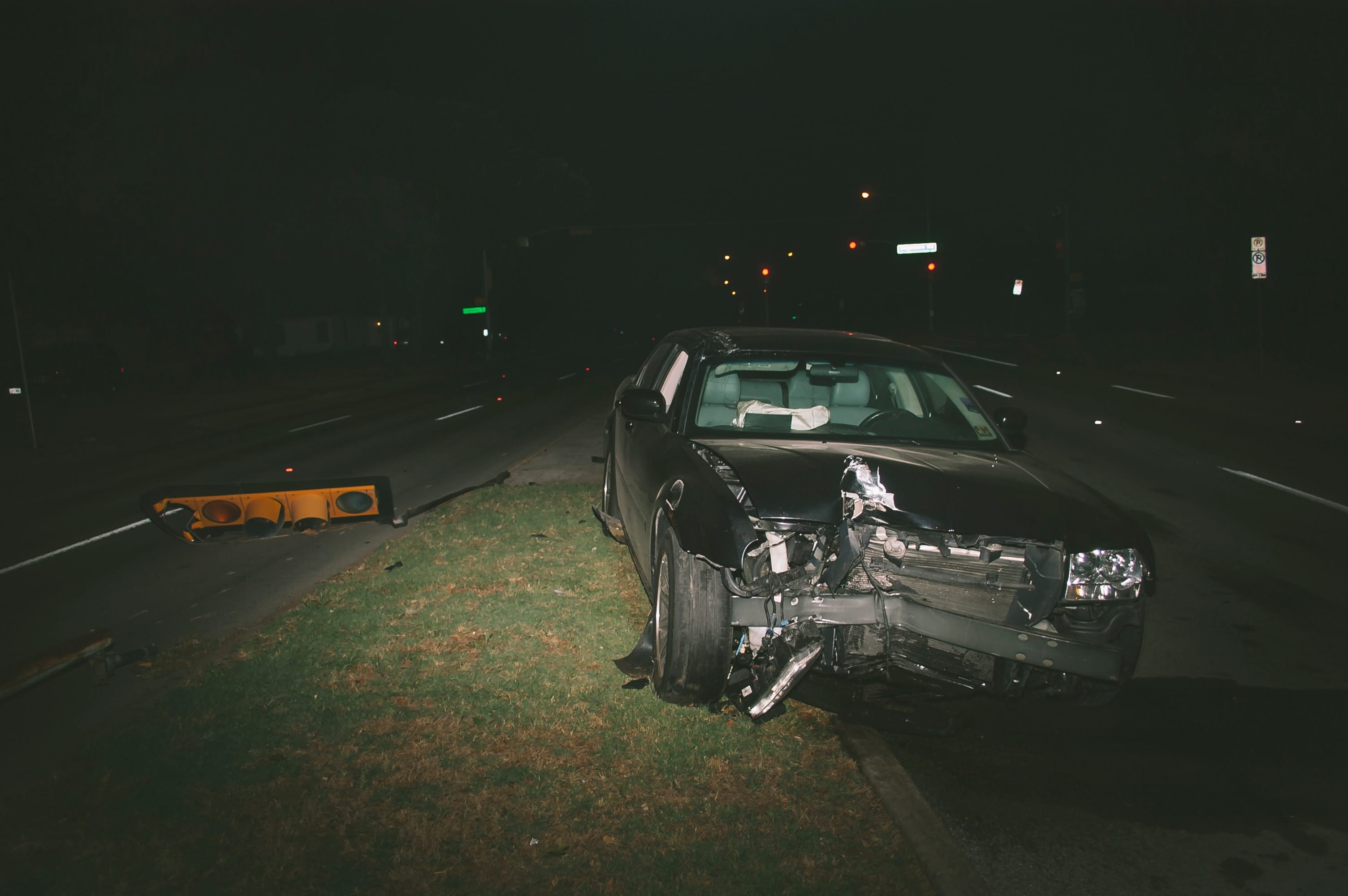 Car accident at night showing vehicle with front-end damage; image by Matthew T. Rader, via Unsplash.com.