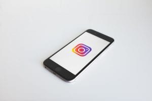 Instagram logo on smartphone; image by NeONBRAND, via Unsplash.com.