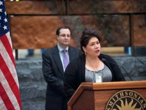 Kimberly Teehee speaking at a podium.