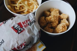 Chicken nuggets, fries, and a sandwich from KFC; image by Aleks Dorohovich, via Unsplash.com.