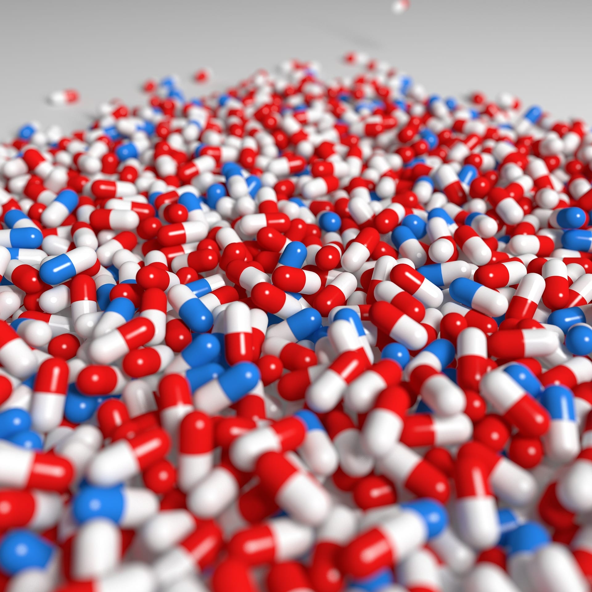 Red/white and blue/white capsules; image by mmmCCC, via Pixabay.com.