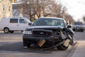 Black car after accident, with left front smashed in; image by Michael Jin, via Unsplash.com.