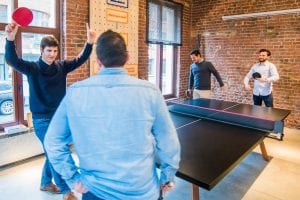 Four men playing table tennis; image by Proxyclick Visitor Management System, via Unsplash.com.