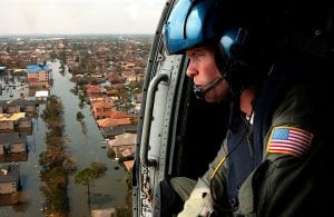 A U.S. Coast Guardsman searches for survivors in New Orleans in the Katrina aftermath