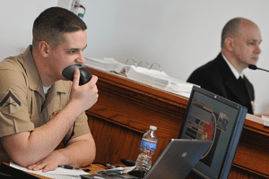 Lance Cpl. Matt Williamson, the court reporter, records testimony during a mock trial at the Naval Justice School (NJS). The mock trial is the final graded event for students at the NJS. U.S. Navy photo by Mass Communication Specialist 2nd Class Eric Dietrich/Released. U.S. Naval War College, CC BY 2.0, no changes.