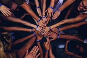 Group of people huddling; image by Perry Grone, via Unsplash.com.