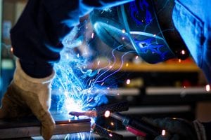 Man welding; image by Rob Lampert, via Unsplash.com.