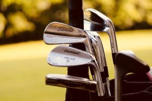 Gray steel golf clubs on selective focus photo; image by Sydney Rae, via Unsplash.com.