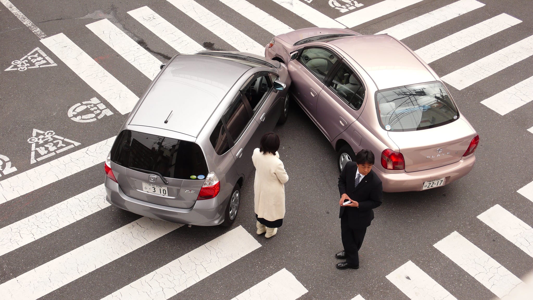 Two cars in an accident in an intersection; image by Shuets Udono, via Flickr, CC BY-SA 2.0, no changes.
