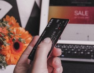 Person holding Visa credit card; image by Anastasiia Ostapovych, via Unsplash.com.