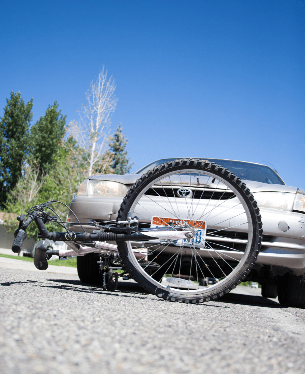 Bike vs. car accident, bike on side in road; image by LosAngeles PersonalInjuryAttorney, via Wikimedia Commons, CC BY-SA 2.0, no changes.