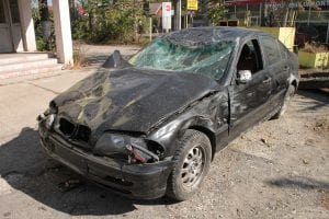 Black sedan with serious front-end damage; image by Byrev, via Pixabay.com.