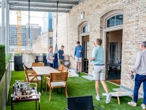 Men playing cornhole boards; image by Austin Distel of www.distel.co, via Unsplash.com.