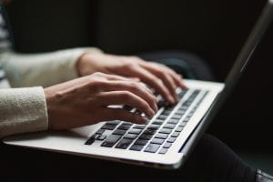 Person using laptop; image by Kaitlyn Baker, via Unsplash.com.