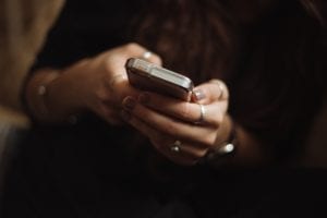 Woman using smartphone; image by Priscilla Du Preez, via Unsplash.com.