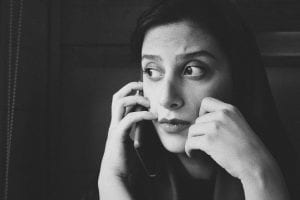 Greyscale photo of woman on a phone call; image by Siavash Ghanbari, via Unsplash.com.