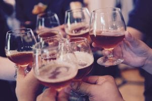 Group of people toasting with snifters; image by Yutacar, via Unsplash.com.