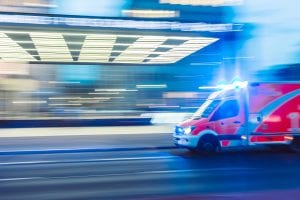 Red ambulance in time-lapse photography; image by Camilo Jiminez, via Unsplash.com.