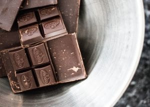 Bowl with pieces of chocolate bar; image by Charisse Kenion, via Unsplash.com.