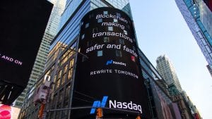 Blockchain billboard in Times Square, New York City, saying “Blockchain making transactions safer and faster. Nasdaq.” Image by Pascal Bernardon, via Unsplash.com.