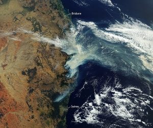 Satellite imagery of wildfire smoke curling up and away from the eastern coast of Australia.