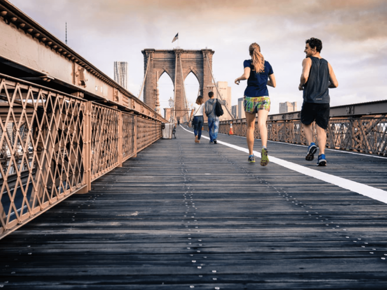 Joggers on the Brooklyn Bridge in New York City; image by Curtis MacNewton, via Unsplash.com.