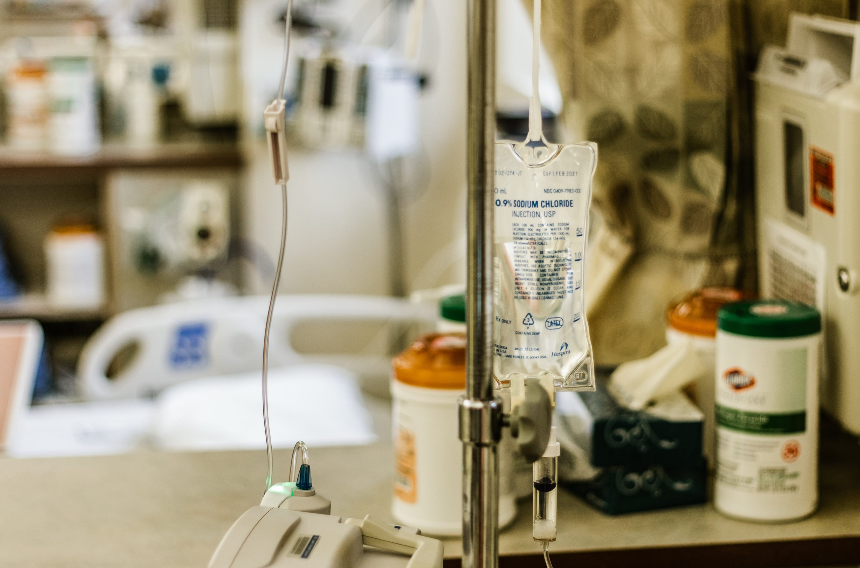 Selective focus photography of IV stand; image by Allie Smith, via Unsplash.com.