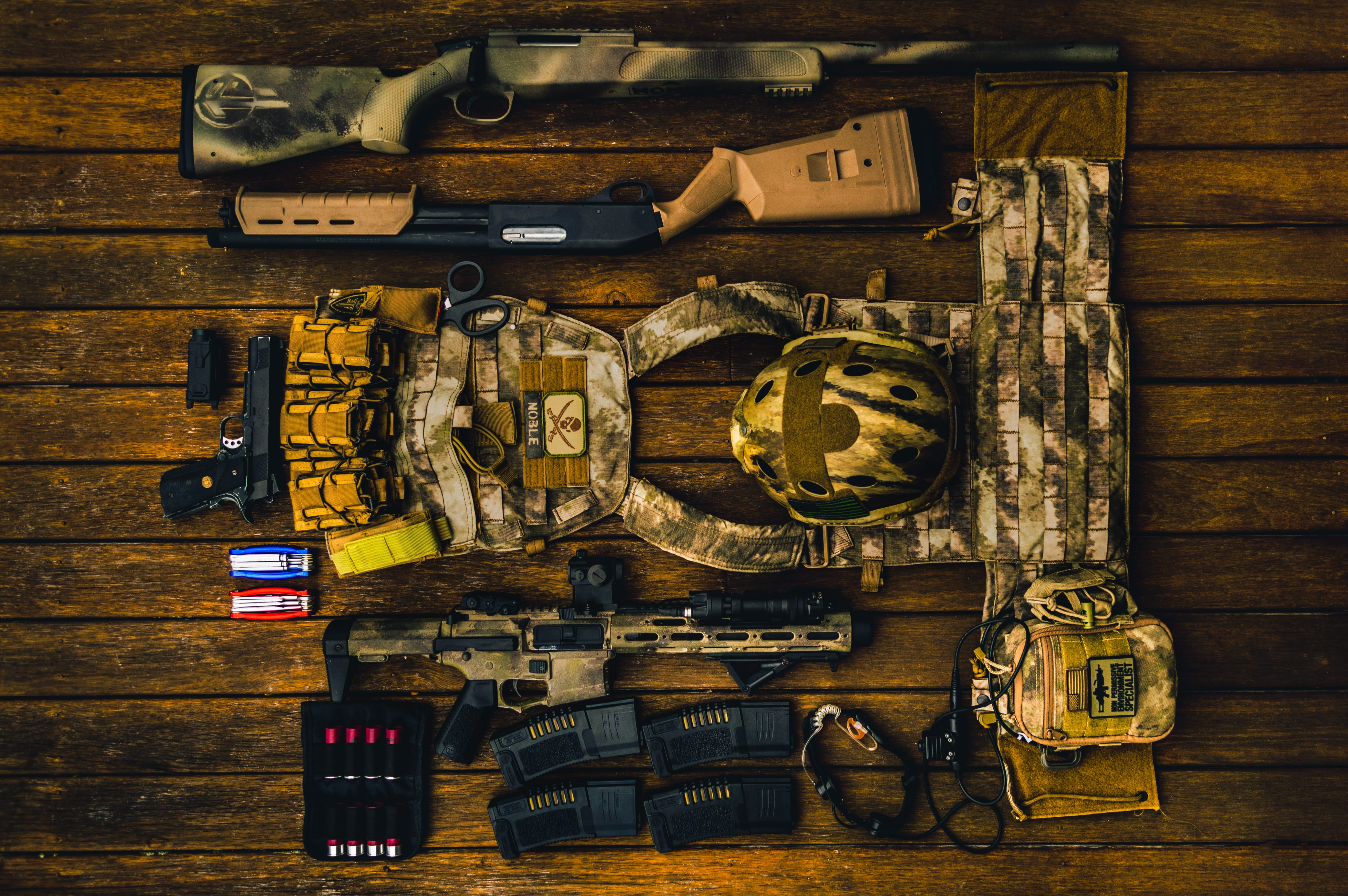 Brown and beige army gear set on brown surface; image by CMDR Shane, via Unsplash.com.