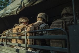 Soldiers in truck; image by Diego González, via Unsplash.com.