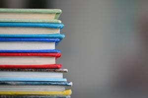 Stack of books; image by Kimberly Farmer, via Unsplash.com.