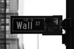 Grayscale photo of Wall St. signage; image by Rick Tap, via Unsplash.com.