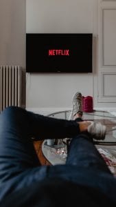 Man watching Netflix; image by Thibault Penin, via Unsplash.com.