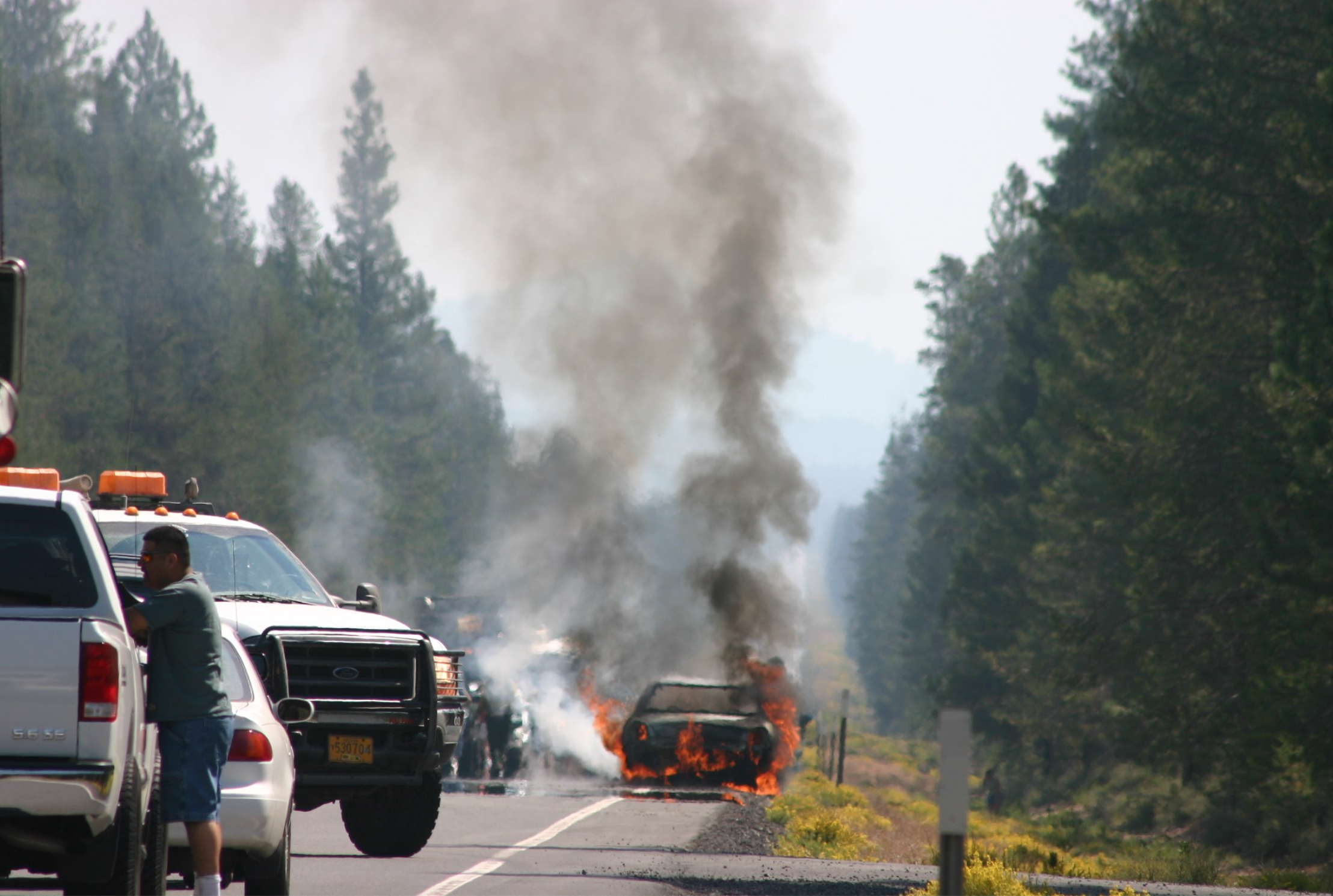 Car on fire after accident; image by Wing-Chi Poon, via Wikimedia Commons, CC BY-SA 2.5, no changes made.