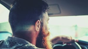 Bearded man driving; image by Abdiel Ibarra, via Unsplash.com.