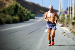 Man running on road; image by Maarten van den Heuvel, via Unsplash.com.