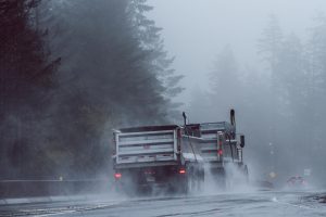 Gravel hauler on the road in the rain; image by Vlad Vasnetsov, via Unsplash.com.