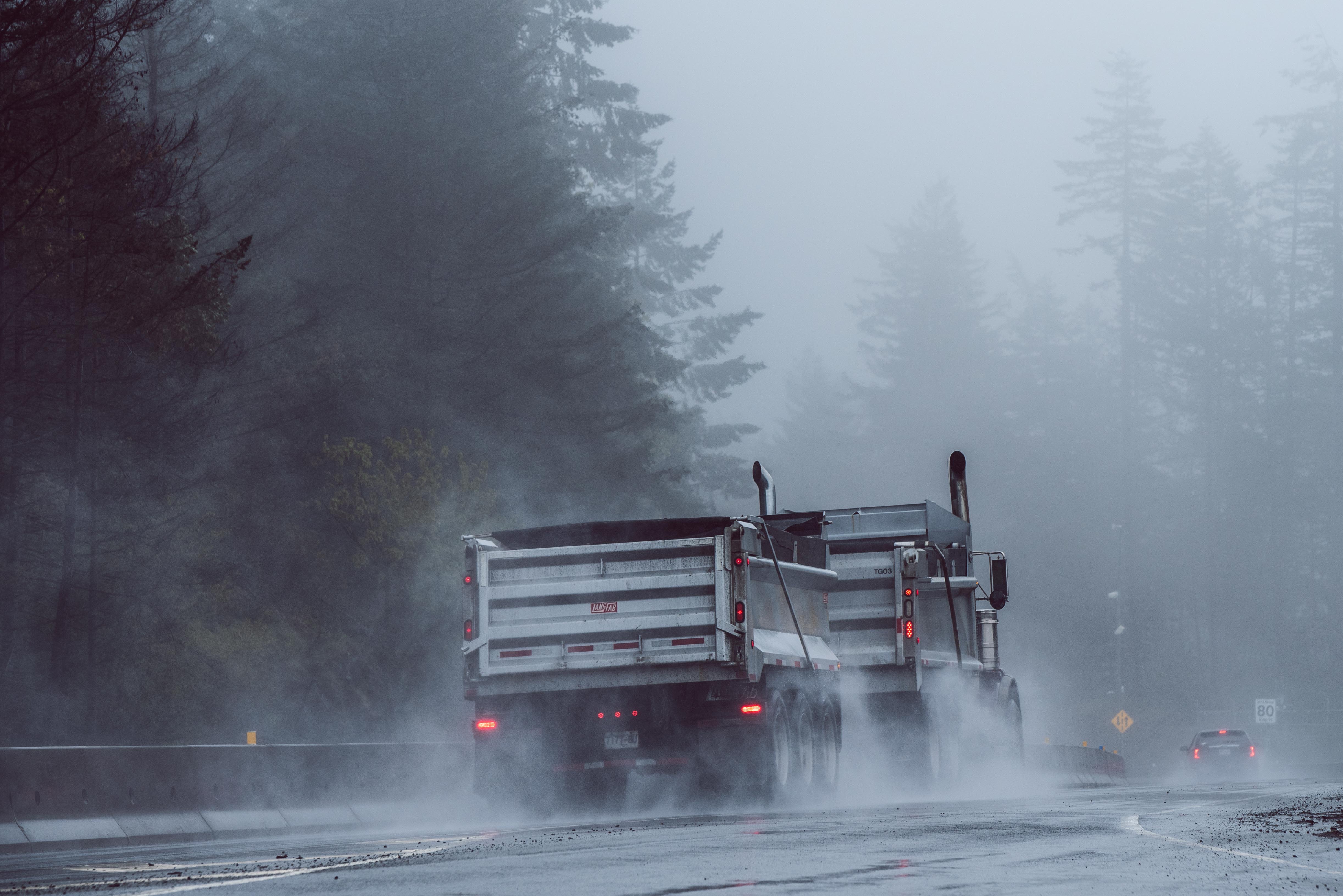 Gravel hauler on the road in the rain; image by Vlad Vasnetsov, via Unsplash.com.