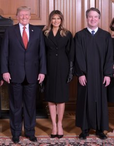 President Trump, First Lady Melania Trump, and Justice Brett Kavanaugh, standing together in a formal setting.