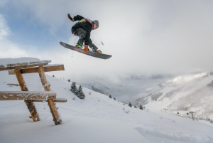 Man going over ramp on a snowboard; image by Visit Almaty, via Pexels.com.