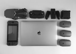 MacBook Pro near black Nintendo Switch, and game controller set; image by Willian Justen de Vasconcellos, via Unsplash.com.