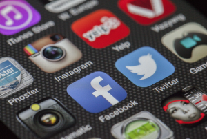 Facebook and Twitter icons together on a smartphone screen; image by LoboStudioHamburg, via Pixabay.com.